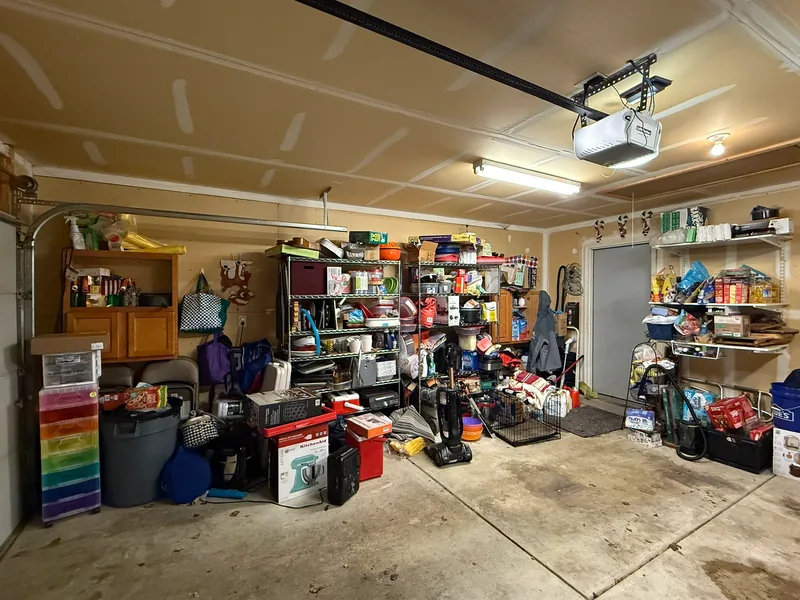Barb's Indianapolis garage before, showing mixed categories and goods on the floor